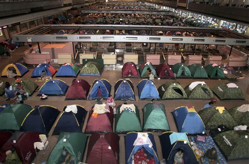 AP Photo - Evacuees from floodwaters rest in tents at an evacuation center in Bangkok